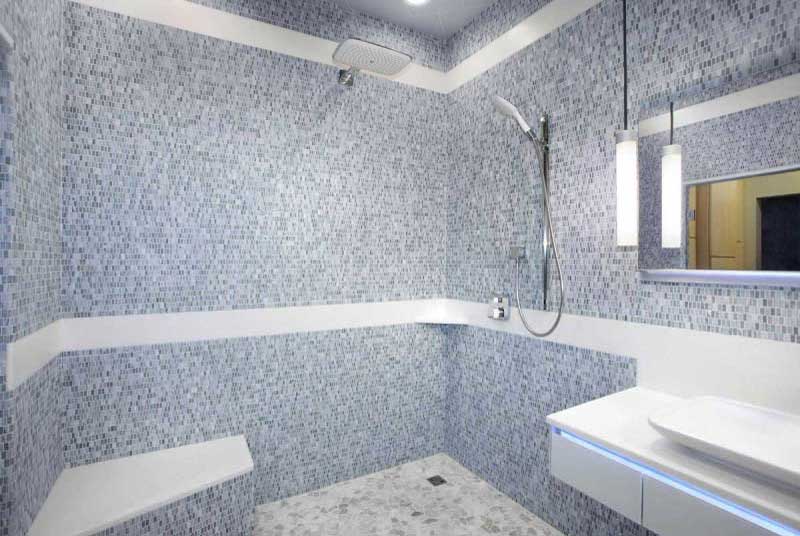 A bathroom with a shower and sink in it