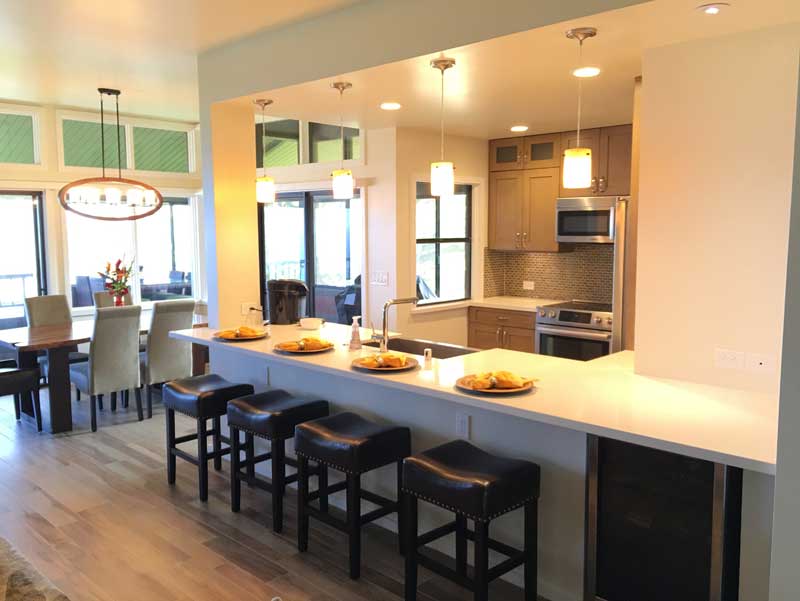 A kitchen with a bar and stools in it