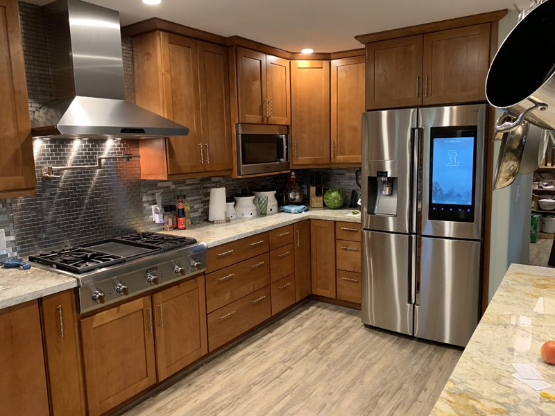 A kitchen with wooden cabinets and stainless steel appliances.