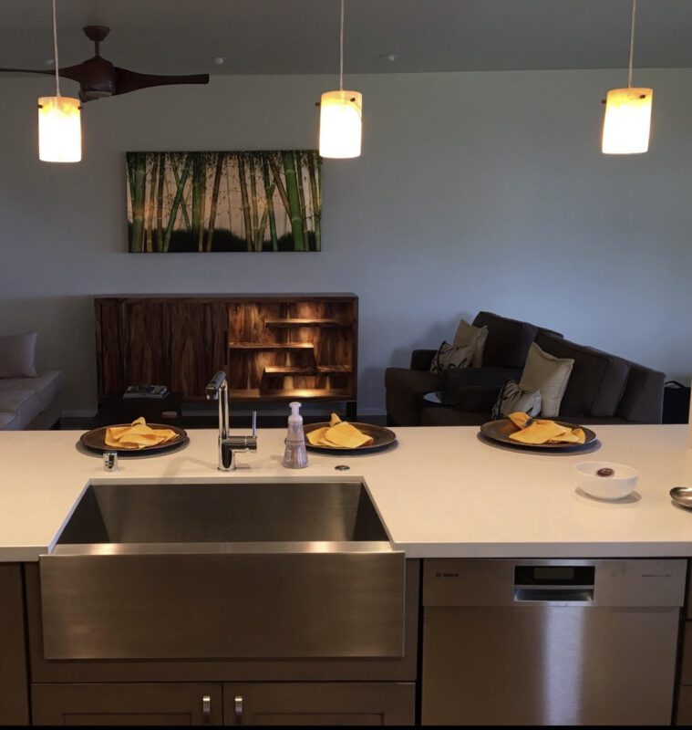 A kitchen with a sink and some lights