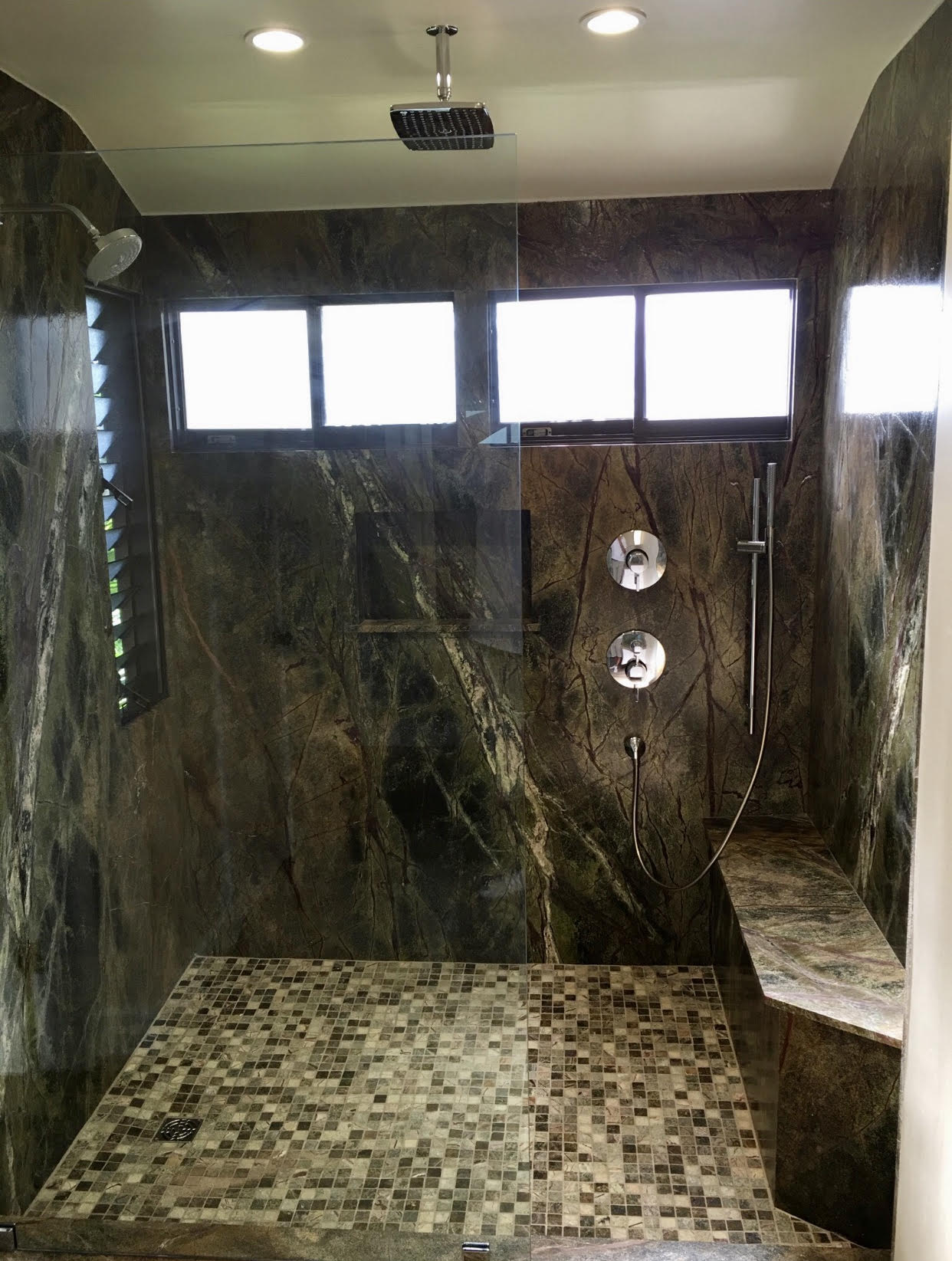 A bathroom with marble walls and floor