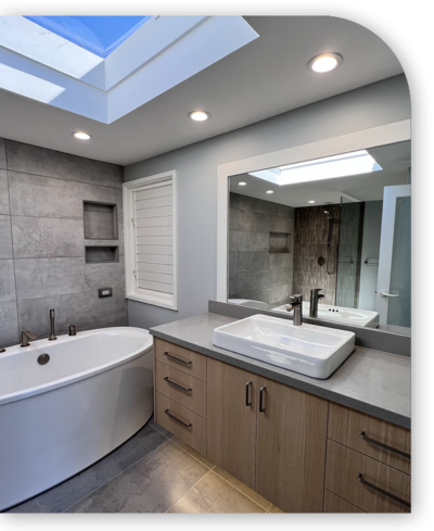 Skylit modern bathroom with freestanding tub